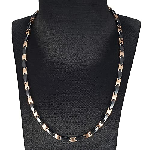 Svart och koppar magnetiskt halsband på byst